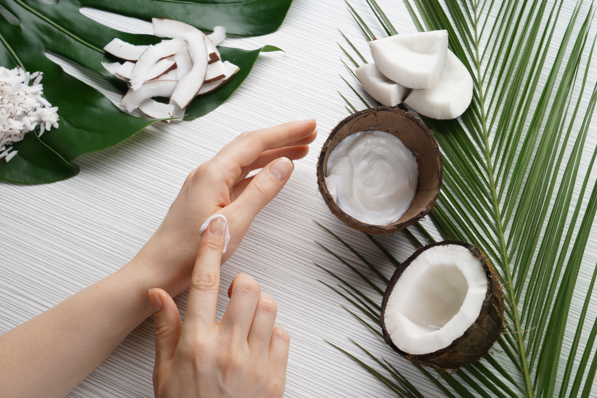 Woman Applying Body Cream with Coconut Extract