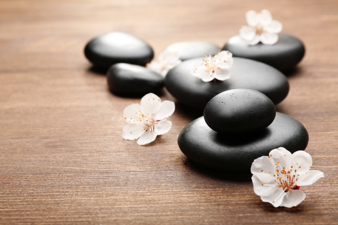 Spa Hot Stones on Wooden Table